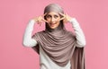 Mysterious muslim girl in hijab framing her eyes with fingers Royalty Free Stock Photo