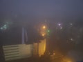 Night cityscape in heavy fog weather. Aerial view
