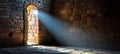 Mysterious Old Stone Cellar Interior Brightly Lit by Light Streaming Through a Narrow Window Royalty Free Stock Photo