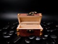 A mysterious open wooden chest surrounded by black stones