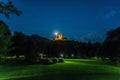 Mysterious Pilgrimage church of Maria of Strassengel in the moonlight in background of a green field Royalty Free Stock Photo