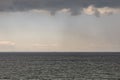 Mysterious rain clouds in the sky and  wavy sea Royalty Free Stock Photo