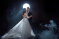 Mysterious and romantic meeting, the bride and groom under the moon. Hugs together. Mixed media Royalty Free Stock Photo