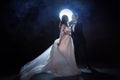 Mysterious and romantic meeting, the bride and groom under the moon. Hugs together.