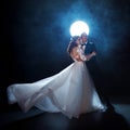 Mysterious and romantic meeting, the bride and groom under the moon. Hugs together. Man and woman, wedding dress.