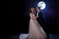 Mysterious and romantic meeting, the bride and groom under the moon. Hugs together. Mixed media Royalty Free Stock Photo