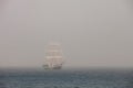 Mysterious sailing ship surrounded fog Royalty Free Stock Photo
