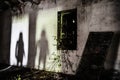 Mysterious shadow of a woman in an abandoned house - Silhouette of female ghost standing on the door of the room - Fear concept in Royalty Free Stock Photo