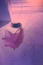Mysterious sleeping girl with long flowing black hair, levitating beauty in long flying pink tender dress, sinking lady Royalty Free Stock Photo