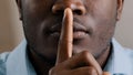 Mysterious unknown male face part african american adult man put finger to lips ask be quiet make gesture silence show Royalty Free Stock Photo