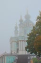 Mysterious view of Saint Andrew\'s Church in the Andriyivskyy Uzviz in fog. Famous touristic place and travel destination.