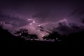 Mysterious view of a lightning in a purple night sky Royalty Free Stock Photo