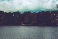 Mysterious view over a lake to a hidden house