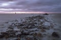 Mysterious water, rocky shore and lighthouse