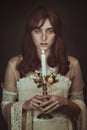 Mysterious woman with candle