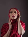 Mysterious woman in the red silk dress of the Eastern Muslim peoples
