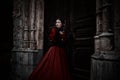 Mysterious woman in red Victorian dress Royalty Free Stock Photo