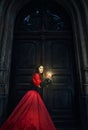 Mysterious woman in a red Victorian dress