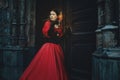 Mysterious woman in a red Victorian dress Royalty Free Stock Photo