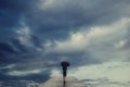 Mysterious woman with umbrella crosses a bridge to the surreal view of the sky Royalty Free Stock Photo