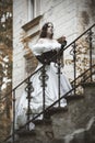 Mysterious woman in a white Victorian dress