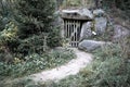 Mysterious wooden doors - gate in forest with stones and path Royalty Free Stock Photo