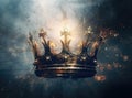 mysteriousand magical image of woman's hand holding a gold crown over gothic black background. Medieval period Royalty Free Stock Photo
