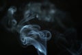 Mystery blue smoke over dark background closeup