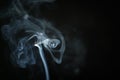 Mystery blue smoke over dark background with copy space