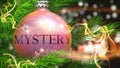 Mystery and Christmas holidays, pictured as a Christmas ornament ball with word Mystery and magic beams to symbolize the