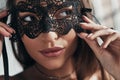 Mystery in her. Attractive young woman wearing a black mask and