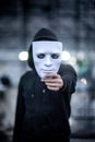 Mystery hoodie man holding white mask Royalty Free Stock Photo