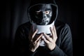 Mystery man in black mask holding white mask Royalty Free Stock Photo