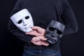 Mystery man holding black and white mask Royalty Free Stock Photo