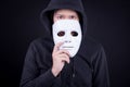 Mystery man holding white mask for hide his face Royalty Free Stock Photo