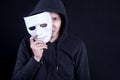 Mystery man holding white mask for hide his face Royalty Free Stock Photo
