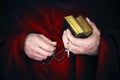 Mystery monk with a cape holding bibles and a black rosary Royalty Free Stock Photo