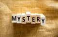 Mystery symbol. The concept word Mystery on wooden blocks. Beautiful canvas background, copy space. Business and mystery Royalty Free Stock Photo