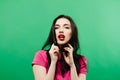 Mystery woman in studio looking away. isolated green background