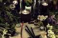 Still life with old book, antique clock, herbs, black candles and ritual objects