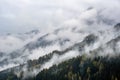 Mystic cloudy and foggy autumn alpine mountain slopes scene. Austrian Lienzer Dolomiten Alps