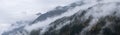 Mystic cloudy and foggy autumn alpine mountain slopes scene. Austrian Lienzer Dolomiten Alps