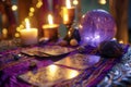 Mystic crystal ball, tarot cards and burning candles on purple background. Magic ritual or spell with esoteric symbols Royalty Free Stock Photo