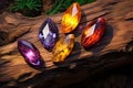 Mystic five small crystals lie on a stone background in the wood, in the style of dark purple and light amber. Royalty Free Stock Photo