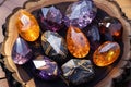 Mystic five small crystals lie on a stone background in the wood, in the style of dark purple and light amber. Royalty Free Stock Photo