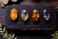 Mystic five small crystals lie on a stone background in the wood, in the style of dark purple and light amber. Royalty Free Stock Photo