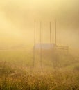 Mystic landscape from the haystack in the morning fog in the mountains among the mountain valleys Royalty Free Stock Photo