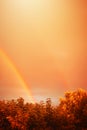 Mystic luminous sky in autumn with rainbow