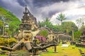 Mystic tropical garden with hindu and buddhist mythological creatures stone sculptures, storm clouds - Buddha Park Wat Xieng