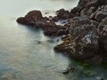 Mystic water and rocks at the ocean - Long exposure nice lanscape with stones on the sea beach. View of water like fog and mist Royalty Free Stock Photo